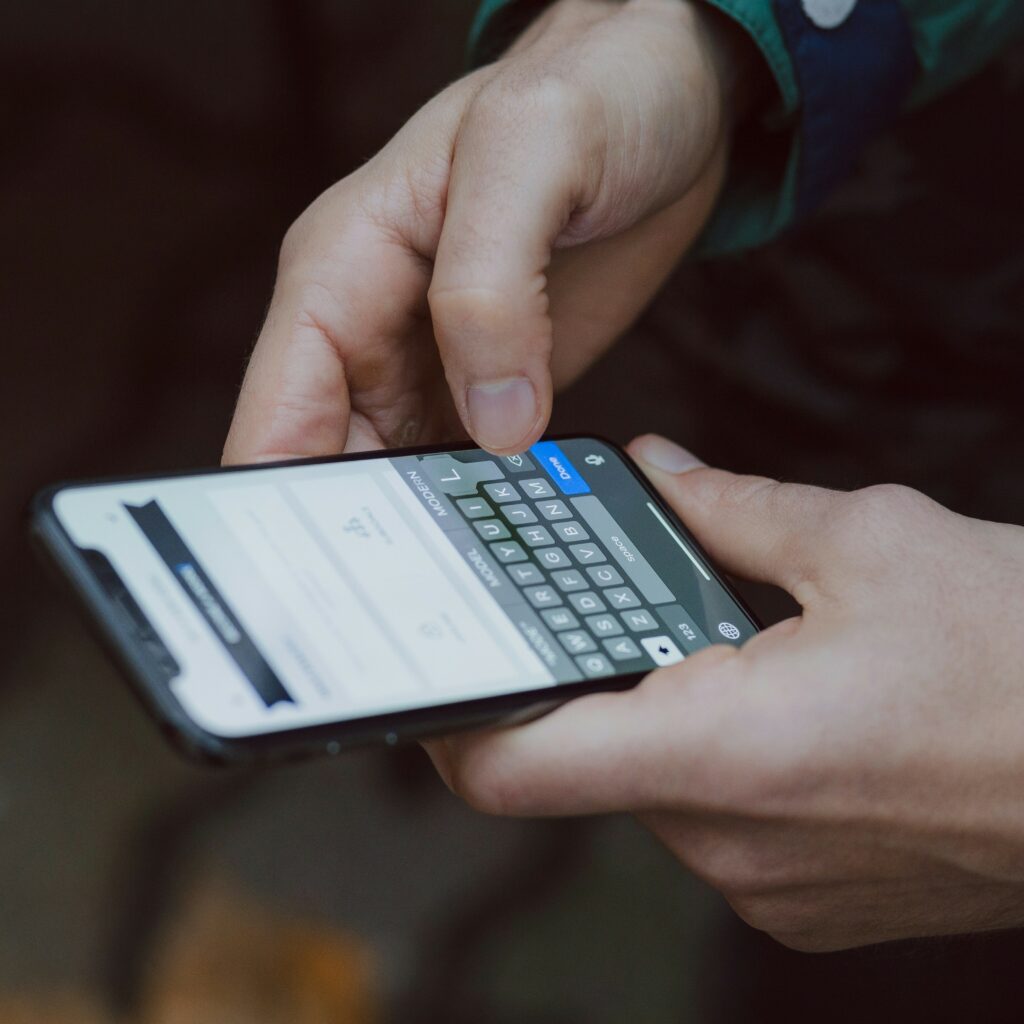 Close-up image of person's hands while holding and texting on a smartphone. Wondering how to get experience as a home inspector? Be responsive on your phone.