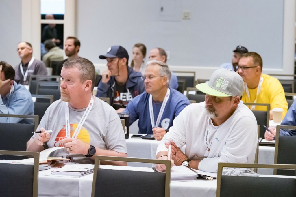 A group of inspectors seated at a home inspector education and home inspector training event, ready to take notes and fill their home inspector continuing education requirements.