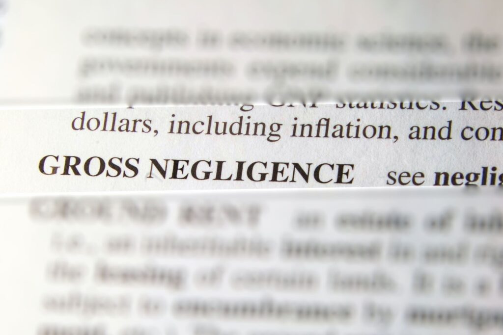 A close-up photo of a dictionary entry for “gross negligence” with surrounding words blurred out. Gross negligence for home inspectors and inspection scope play key roles in this case study.