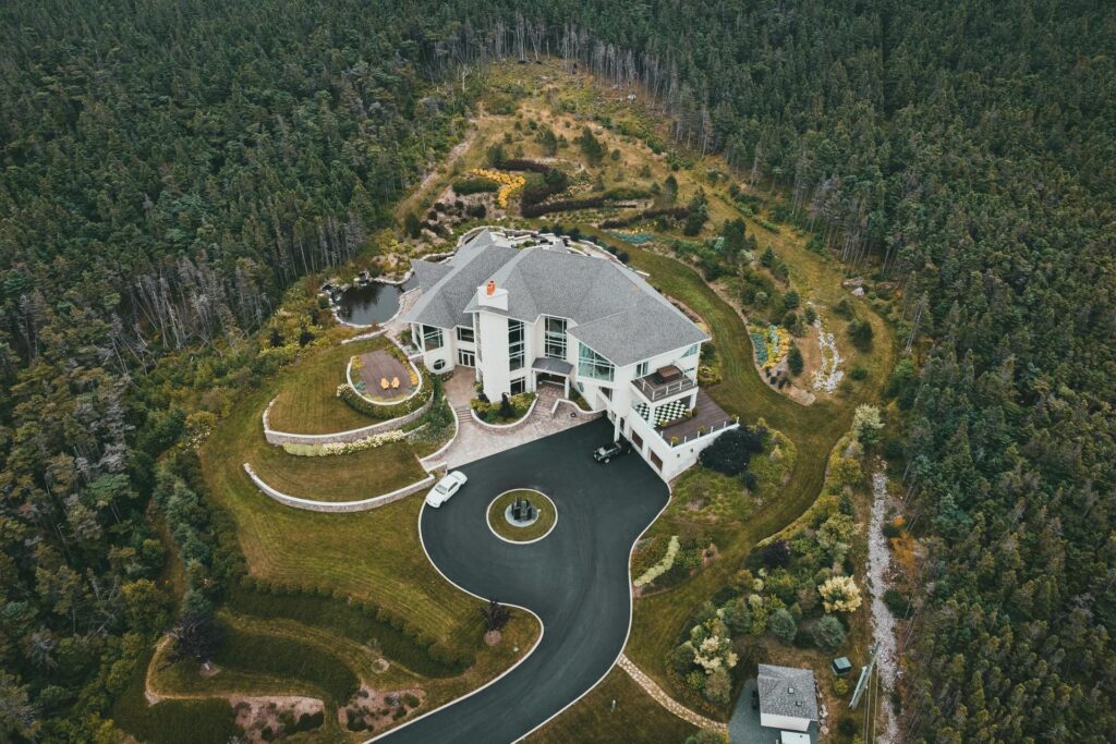 An aerial view of a higher square footage, luxury property with multiple stories, as one might see while performing big home inspections and inspecting huge houses.