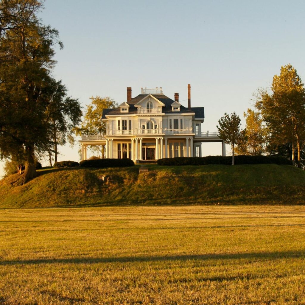 A huge estate set on a hill, like what you might see before starting a luxury home inspection.